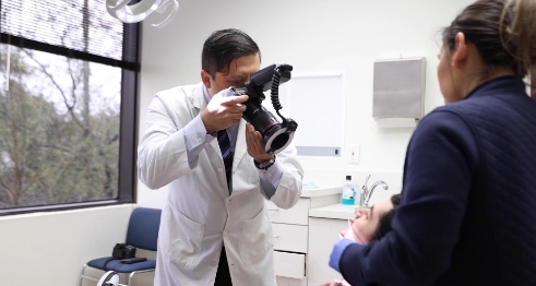 Cypress oral surgeon taking a photo of a patient's mouth