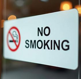 No smoking sign attached to glass pane