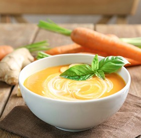 Bowl of creamy soup on tabletop