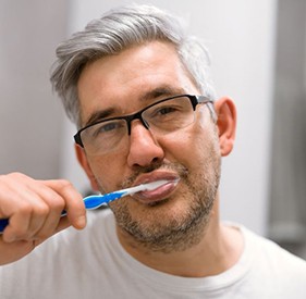 Middle-aged man brushing his teeth