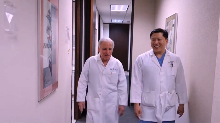 Two oral surgeons walking down a hallway