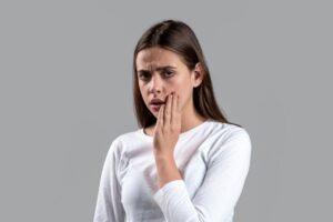 Concerned woman touching the side of her face 